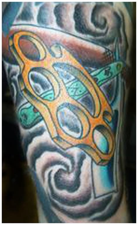 Brass knuckles tattoo by Eric Paluch aka Chico: TattooNOW