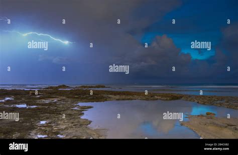 Storm weather with lightning on sea beach Stock Photo - Alamy