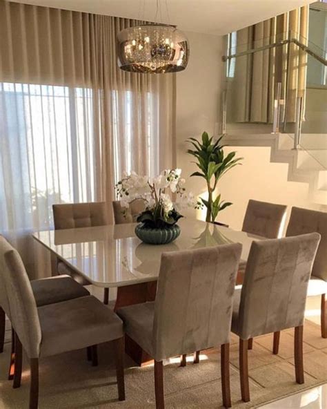 The Dining Room Table Is Surrounded By Beige Chairs