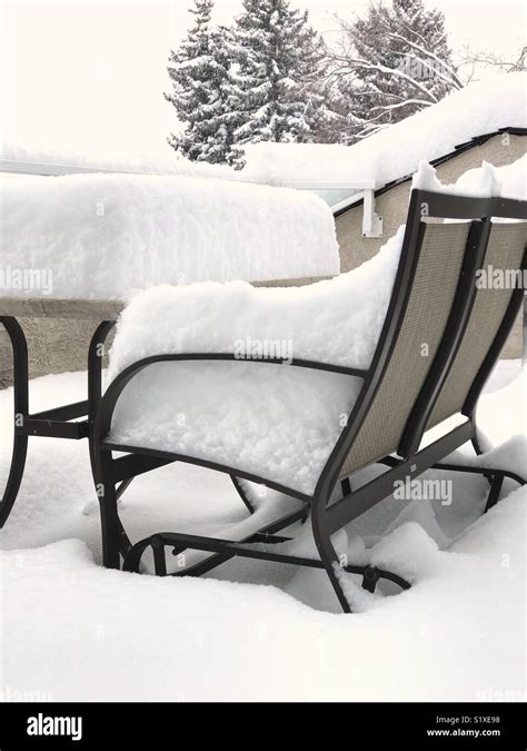 A large overnight snowfall covers patio furniture Stock Photo - Alamy