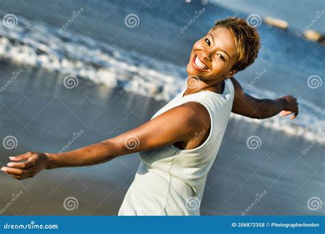 Portrait Of Cheerful African American Woman Enjoying Vacation On Beach