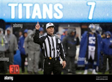 NFL official Shawn Hochuli, a referee, gestures during the second half ...