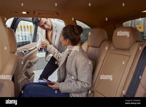 Gallant Man Helping Woman Out Of Car Stock Photo Alamy