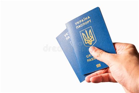 Two Ukrainian Biometric Passports In A Woman`s Hand On A White