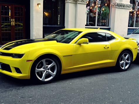 Yellow Chevroelt Camaro Parked Outside of Building · Free Stock Photo