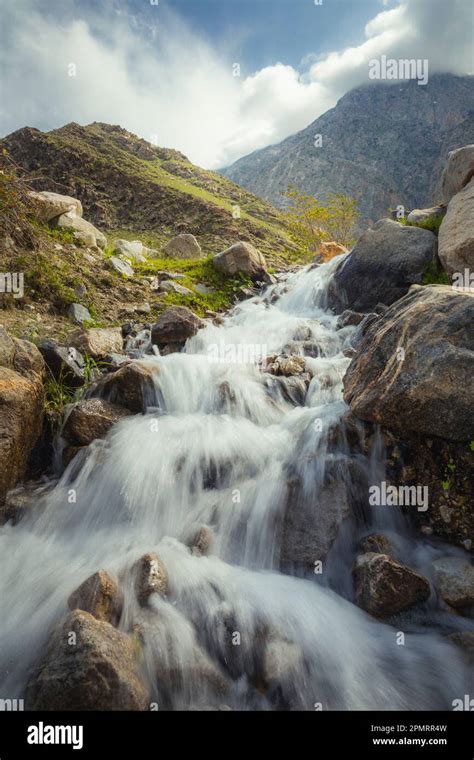 A beautiful photo of a waterfall with the mountains in the background ...