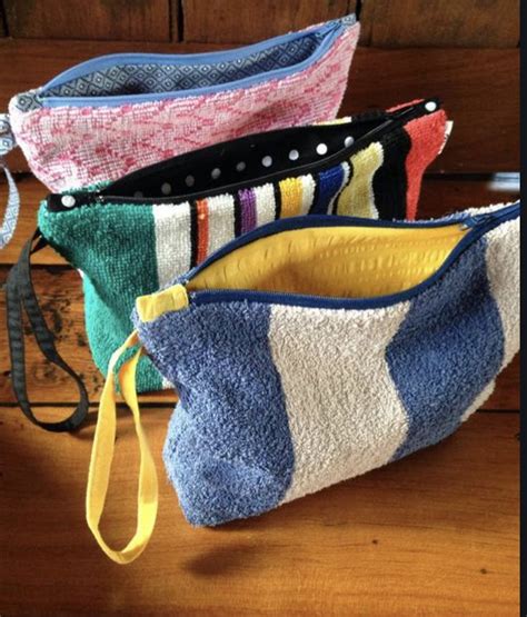 Three Purses Sitting On Top Of A Wooden Table