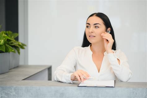 Premium Photo Portrait Of Beautiful Receptionist Near Counter In Hotel