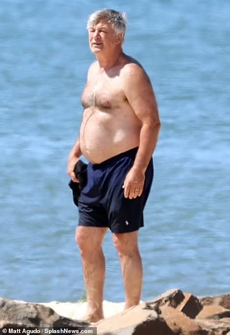 Alec Baldwin 64 Shows Off Shirtless Physique As He Frolics Across The