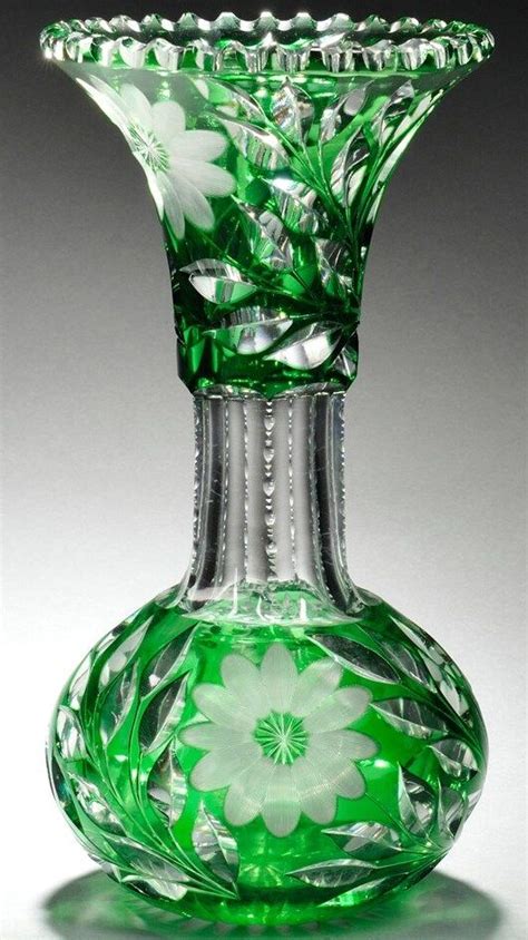 A Green Glass Vase Sitting On Top Of A Table