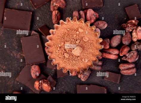 Cocoa Beans Background On Brown Table Dark Chocolate Pieces And