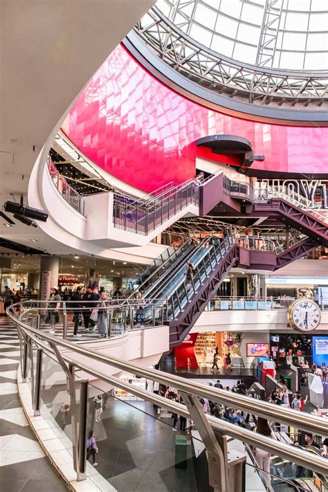 Download A Large Shopping Mall With People Walking Around