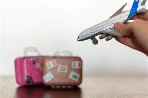 Premium Photo Cropped Hand Holding Toy Airplane Over Table