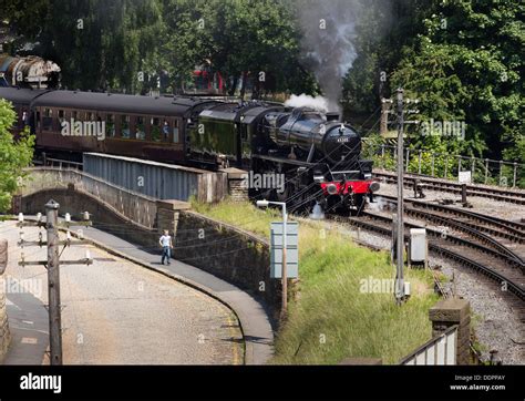 A Boy Racing A Steam Train As It Pulls Out Of Keighley Station On The