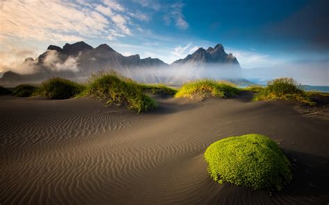 Islândia belas paisagens montanhas praia musgo areia mar nuvens