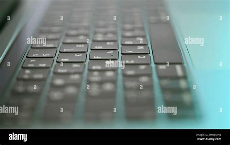 Side view of laptop or computer details, black keyboard with white symbols. Extreme close up of ...