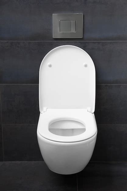 Premium Photo | White toilet on a black wall