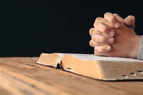 Premium Photo Prayer Man Holding Cross With Bible