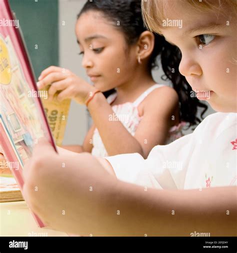 Two Students Reading In A Classroom Stock Photo Alamy