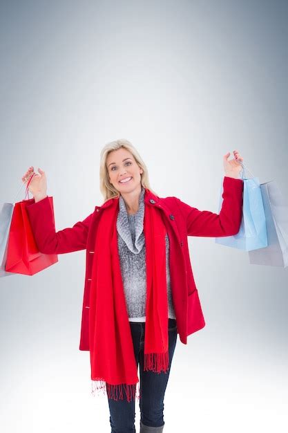 Premium Photo Blonde In Winter Clothes Holding Shopping Bags