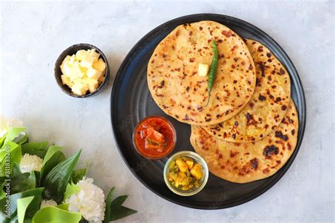 Indian Food Aloo Paratha Or Indian Potato Stuffed Flatbread Served With Butter For Breakfast