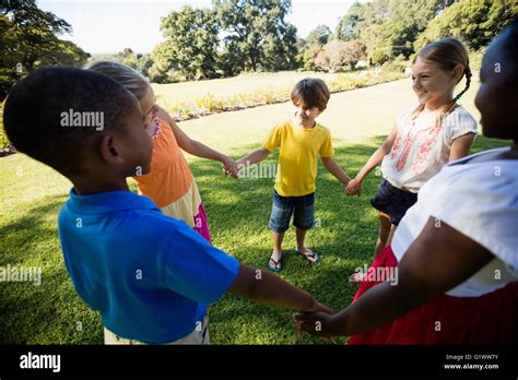 Kids playing together during a sunny day Stock Photo - Alamy