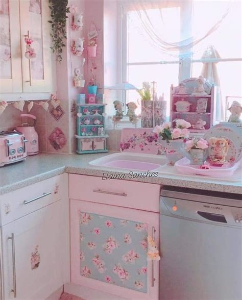 A Kitchen With Pink And White Decor On The Walls