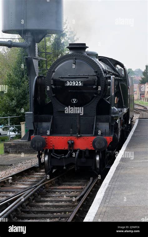 Cheltenham 30925 Schools Class Steam Locomotive Passing A Water Tower