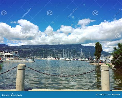 Downtown Kelowna marina editorial stock photo. Image of clouds - 113022113