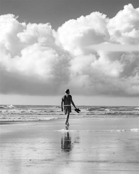 Man Walking Barefoot at Beach · Free Stock Photo