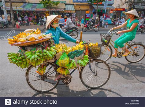 Download This Stock Image Vietnam Street Woman A Female Vendor Wheels Her Bicycle Laden With