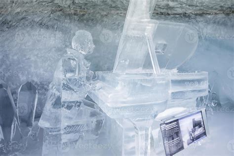 Ice Statue Of Man Playing Piano In Glacier Tunnel Inside Ice Palace