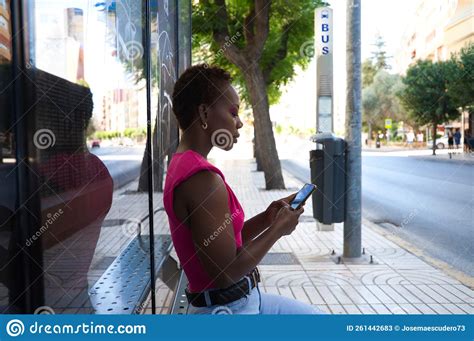 Young And Beautiful Afro American Woman Sitting At The Bus Stop