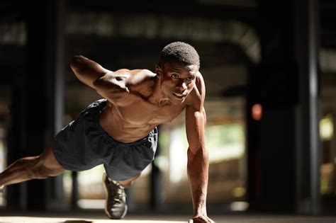 Premium Photo | Fitness black man exercising push ups Male model ...