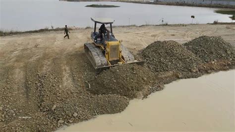 Skills Operator Spreading Gravel Rock Bulldozer Dump Truck On New Land