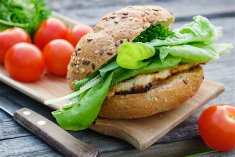 Tasty Homemade Burger With Meat Lettuce Tomatoes Bun On Picnic Table