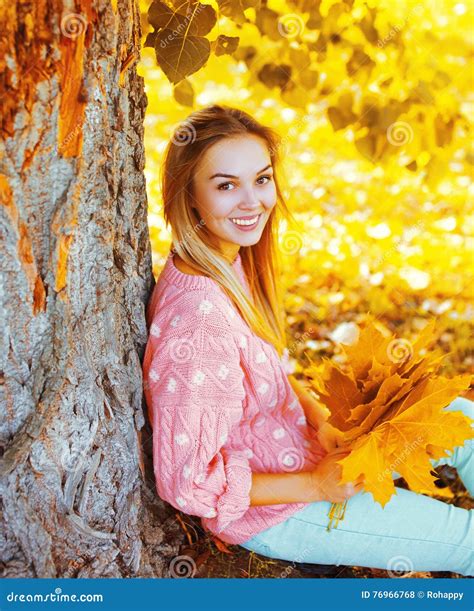 Portrait Beautiful Smiling Woman With Yellow Maple Leafs Sitting Under