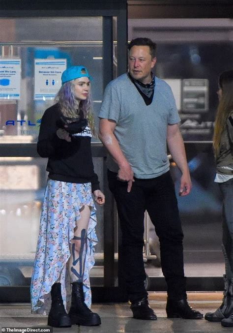 Elon Musk with his wife and little son at the airport