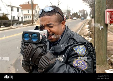 Police officer using radar gun Stock Photo - Alamy