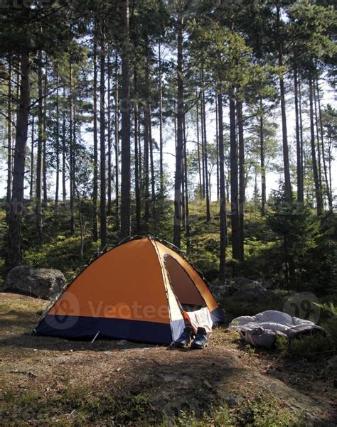 Wild camping - Small orange tent in a forest in Sweden 10307085 Stock Photo at Vecteezy