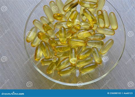 Omega 3 And Vitamin D Fish Oil Capsules In A Glass Plate Stock Photo