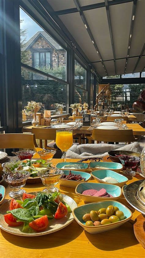 A Wooden Table Topped With Lots Of Plates And Bowls Filled With