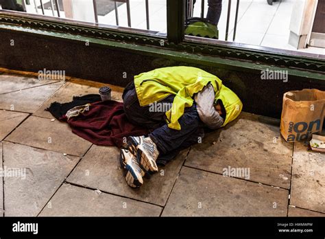 Homeless Man Sleeping Rough On A Pavement London England UK Stock