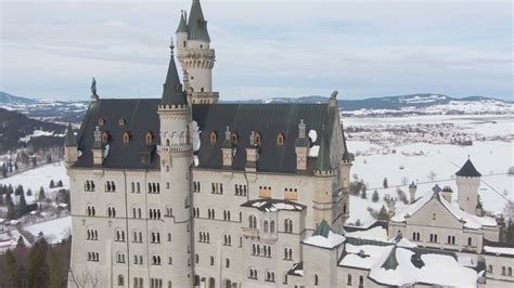 Neuschwanstein Castle in Winter Day. Mountains and Snow Field. Bavarian