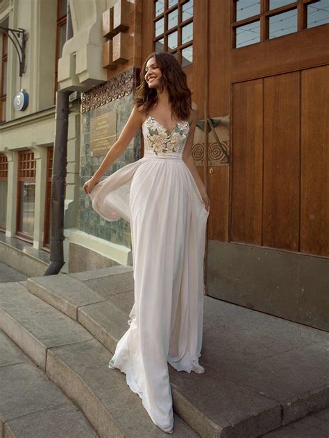 Chiffon wedding gown with spaghetti straps and colored embroidery