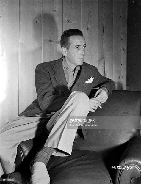 Posed Portrait Of Actor Humphrey Bogart Sitting On An Armchair And