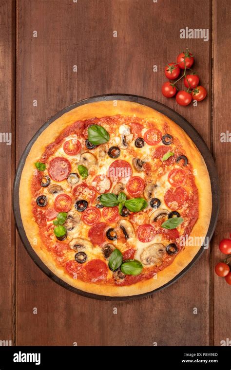 Overhead Photo Of Pepperoni Pizza With Cherry Tomatoes And Fresh Basil