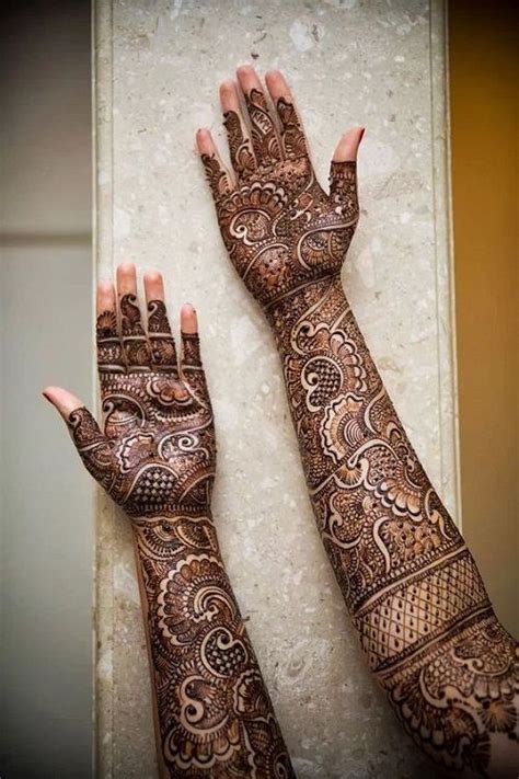 Two Hands With Henna Tattoos On Them