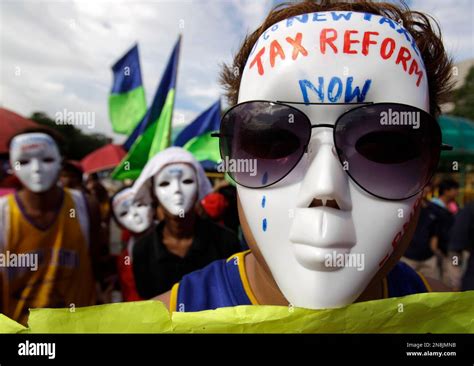 A Filipino Protester Wears A Mask Bearing A Slogan As Tobacco Farmers