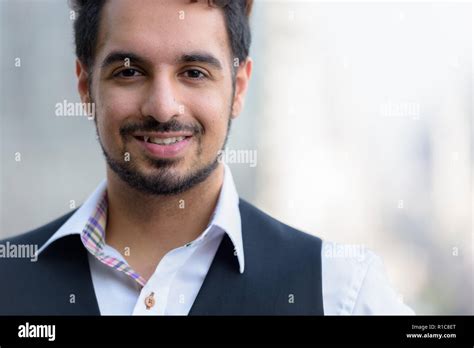 Close Up Of Young Happy Indian Man Smiling Outdoors In The City Stock